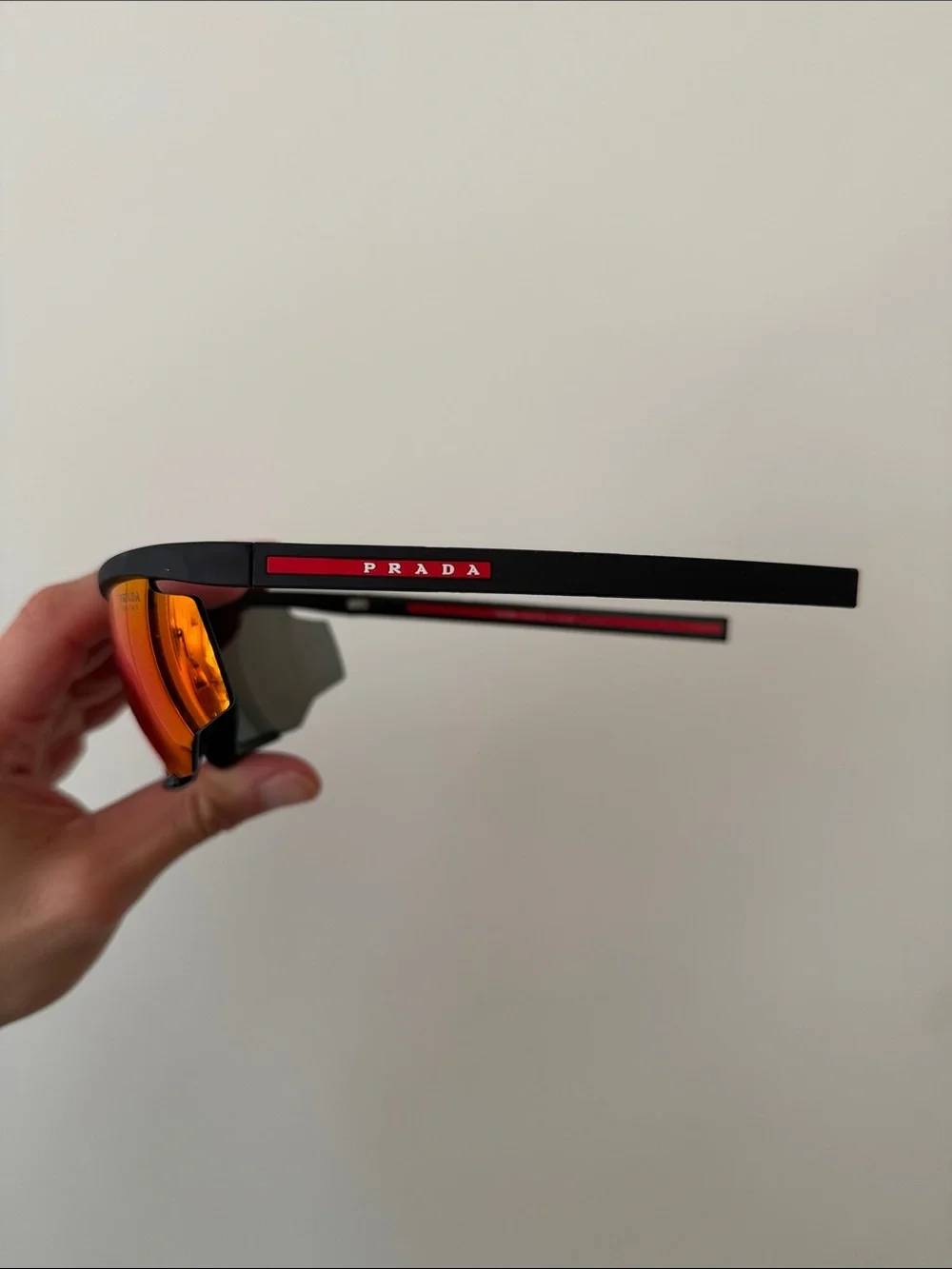 Prada Sports Sunglasses with Red Mirrored Lenses